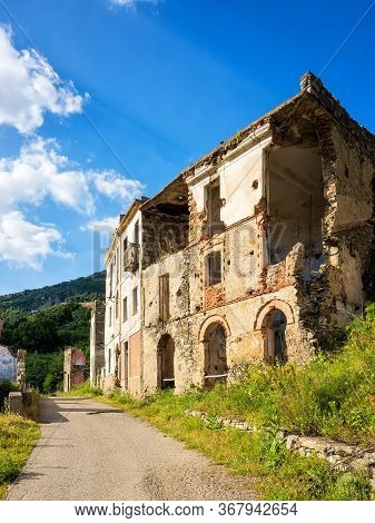Ruined Buildings Of An Abandoned City. Architecture Of A Ghost Town.