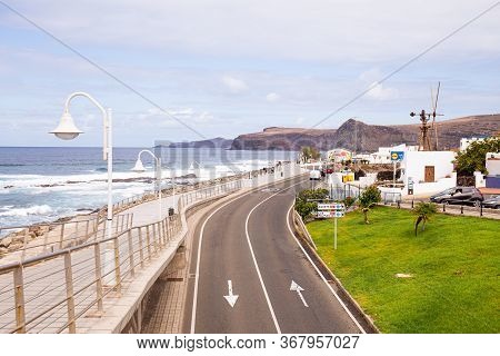 Agaete, Las Palmas - October 17, 2019: Seafront With Atlantic Ocean, Rocks, Road And Buildings In Ag