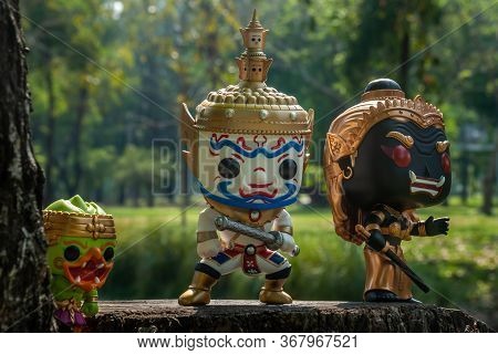 Ravana, Giantess And Hanuman. Standing On The Base Of A Large Tree At The Park. Traveller Doll.
