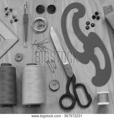 Miscellaneous Accessories, Sewing Threads, Fabric, Tailor's Scissors And A Pattern Lie On A Wooden T