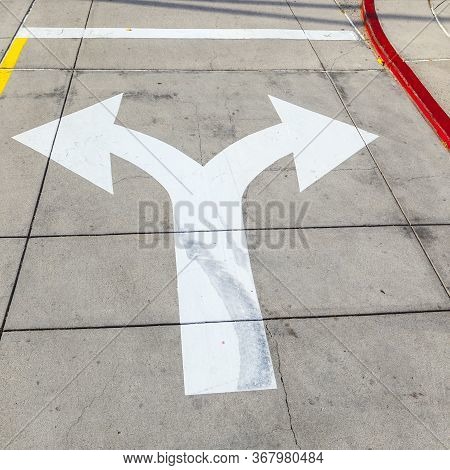 Arrows And Lines On The Asphalt To Indicate The Direction Of Driving