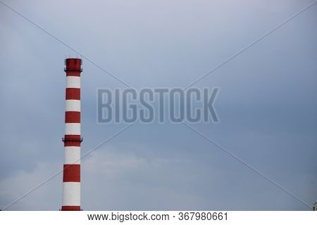 Red And White Factory Chimney, On Cloudy Sky. Polution Concept