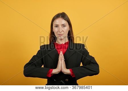 Young Attractive Brunette Woman In Black Stylish Suit, Red Shirt On Yellow Background, Focused Relax