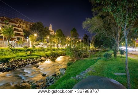 The Tomebamba River At Night, Next To A Popular Park And Residential Area Of Cuenca, Ecuador, South 