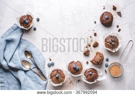 Homemade Fresh Chocolate Muffins With Berries And Chocolate Pieces. Top View. Copy Space For Text.