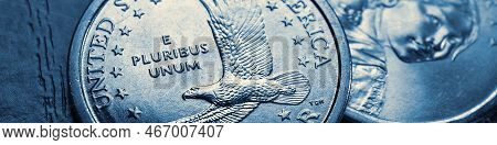 American Coins Closeup Lie On Dark Surface Of Office Table. Soaring Eagle Sacagawea Dollar Coin. Us 