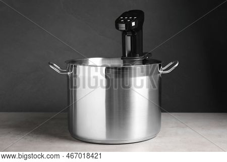 Sous Vide Cooker In Pot On Light Grey Table. Thermal Immersion Circulator