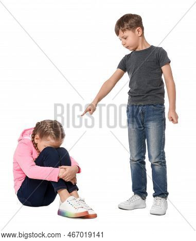 Boy Pointing At Upset Girl On White Background. Children's Bullying