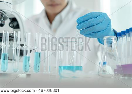 Scientist Analyze Biochemical Samples In Advanced Scientific Laboratory. Medical Are Mixing Chemical