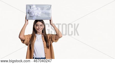 Smiling Teen Girl Holding Birthday Gift In Studio. Teen Girl With Birthday Gift Box.