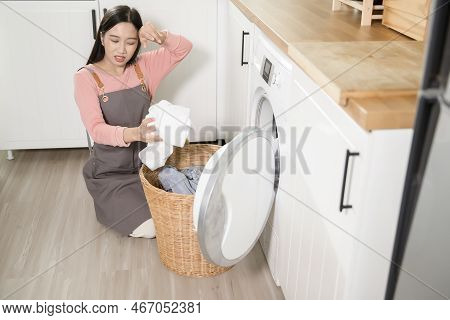 Exhausted  Asian Young Woman With Dirty Clothes , Doing Laundry In Home