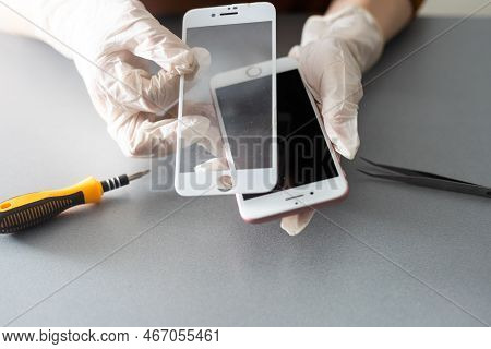 Kiev, Ukraine - December 10, 2022: Close-up Iphone Repair, Replacement Of Protective Glass