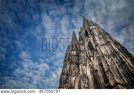 Cologne Cathedral Seen From Below With Blue Sky. Cologne Cathedral, Or Kolner Dom, Is The Main Landm