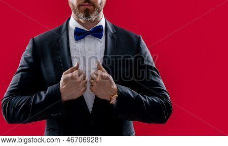 Man In Tux Isolated On Red Background With Copy Space. Tux Man In Studio. Photo Of Man Wearing Tux