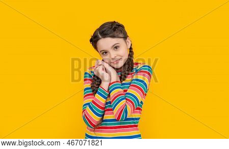 Childhood Studio Shot Of Smiling Teen Braided Girl. Teen Braided Girl Isolated On Yellow Background.