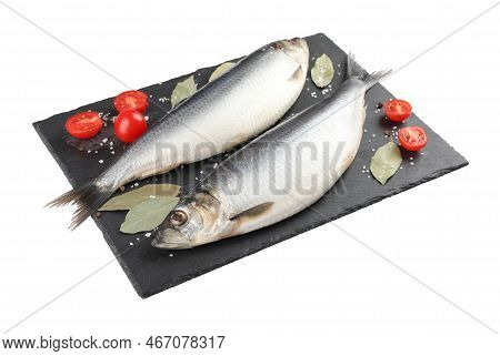 Slate Plate With Salted Herrings, Bay Leaves, Cherry Tomatoes And Spices Isolated On White