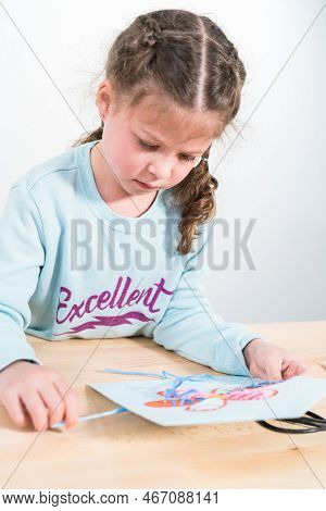 Little Girl Learning How To Sew With Sewing Craft Kit For Kids.