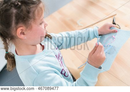 Little Girl Learning How To Sew With Sewing Craft Kit For Kids.