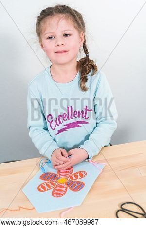 Little Girl Learning How To Sew With Sewing Craft Kit For Kids.