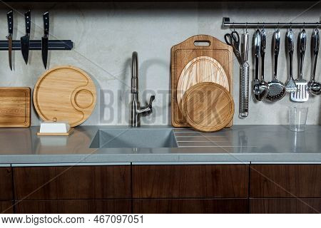 Working Area Of The Kitchen. Kitchen Cabinet With Jars, Cups, Spices, Plates, Kitchen Countertop Wit