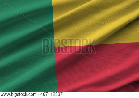 Benin Flag With Big Folds Waving Close Up Under The Studio Light Indoors. The Official Symbols And C