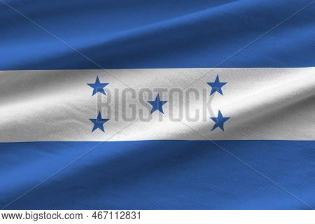Honduras Flag With Big Folds Waving Close Up Under The Studio Light Indoors. The Official Symbols An
