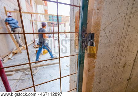 Close Up View On Metal Lattice Door, As A Barrier, Locked Up With Padlock, Entrance For Authorized P