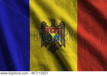 Moldova Flag With Big Folds Waving Close Up Under The Studio Light Indoors. The Official Symbols And