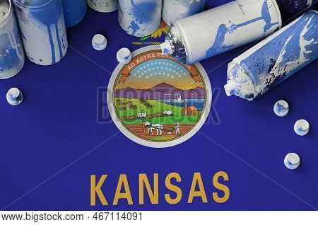 Kansas Us State Flag And Few Used Aerosol Spray Cans For Graffiti Painting. Street Art Culture Conce