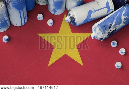 Vietnam Flag And Few Used Aerosol Spray Cans For Graffiti Painting. Street Art Culture Concept, Vand