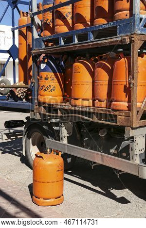 Madrid, Spain- December 13, 2022:truck Delivering Traditional Metal Butane Gas Bottles At Home In Sp