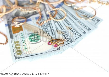 Many Expensive Golden Jewerly Rings, Earrings And Necklaces With Big Amount Of Us Dollar Bills On Wh