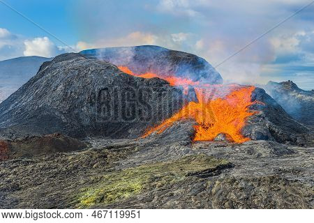 Active Volcano On The Reykjanes Peninsula. Strong Lava Flow From A Volcanic Crater In Iceland. Liqui