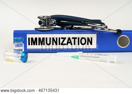Medical Concept. On A White Surface, A Syringe, A Stethoscope And A Folder With The Inscription - Im