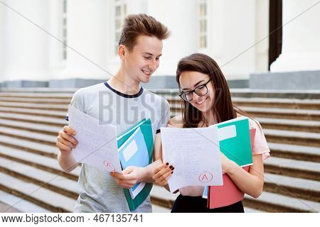 Female Student Brags Her Results Of The Test With Male Friend. Happy Students Received A Grade For T