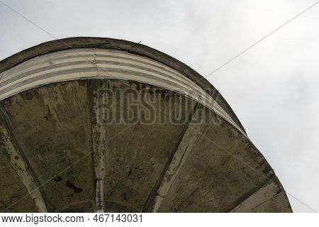 Old, Concrete Historical Water Tower .view From Below On The Upper Part Of The Building, Against The