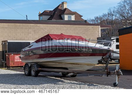 Harmar Township, Pennsylvania, Usa December 13, 2022 A Semi Covered Motorboat On A Trailer Parked In