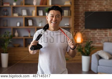 Active Sporty Lifestyle. Excited Japanese Middle Aged Man Holding Trx Resistance Bands Hang Around H