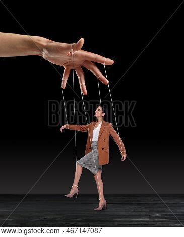 Human Relationships Demonstrated In Puppet Show. Worker Manipulated By Director Or Manager On Black 