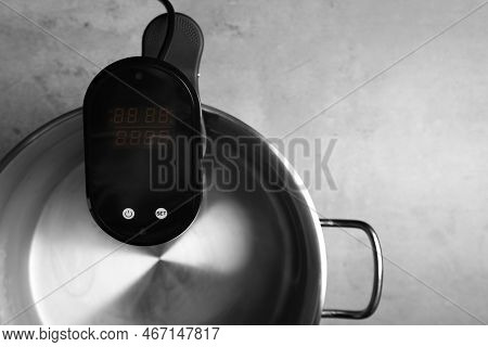 Sous Vide Cooker In Pot On Light Grey Table, Closeup. Thermal Immersion Circulator