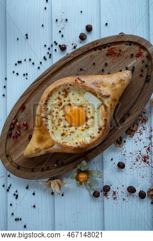 Fresh Adjarian Khachapuri Boat Woth Suluguni Cheese, Egg Yolk And Butter