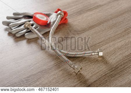 Tube, Tape Fum And Work Gloves On Wooden Background, Closeup Photo