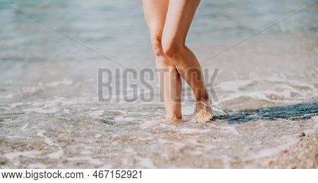 A Woman Walks Along The Beach, Legs Close-up. Barefoot Woman Sta