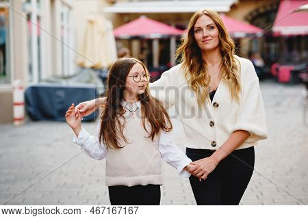Young Mother And School Preteen Girl Making Walk In The City. Happy Family, Woman And Daughter With 