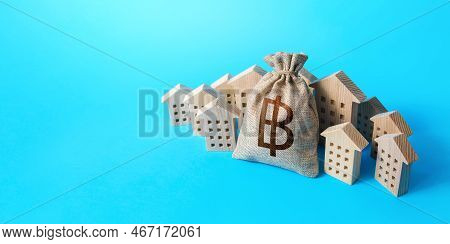 Thai Baht Money Bag Surrounded By Houses. Real Estate Investment. Buying Apartments. Mortgage Loan. 