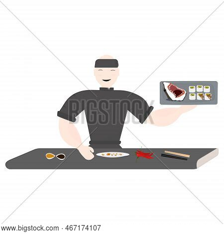 An Asian Chef Prepares Sushi. He Stands At The Table In A Black Coat.