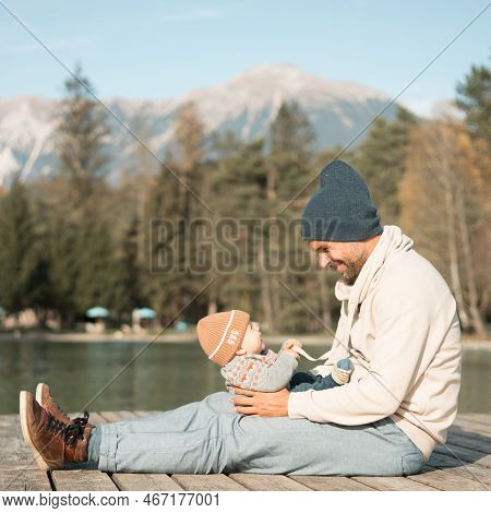 Happy Family. Father Playing With Her Baby Boy Infant Oudoors On Sunny Autumn Day. Portrait Of Dad A
