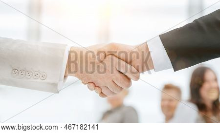 Through The Blinds. Handshake Of Business People. Business Background. Handshake At Sunset With A Su