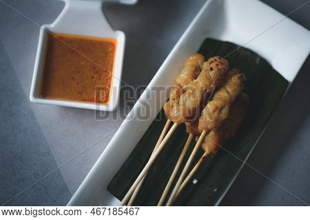 Grilled Pork Served With Peanut Sauce Or Sweet And Sour Sauce, Thai Food, Street Food.