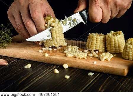 Chef Cuts The Grains Of Boiled Corn With A Knife. Maize Is An Excellent Dietary Breakfast Or Lunch B
